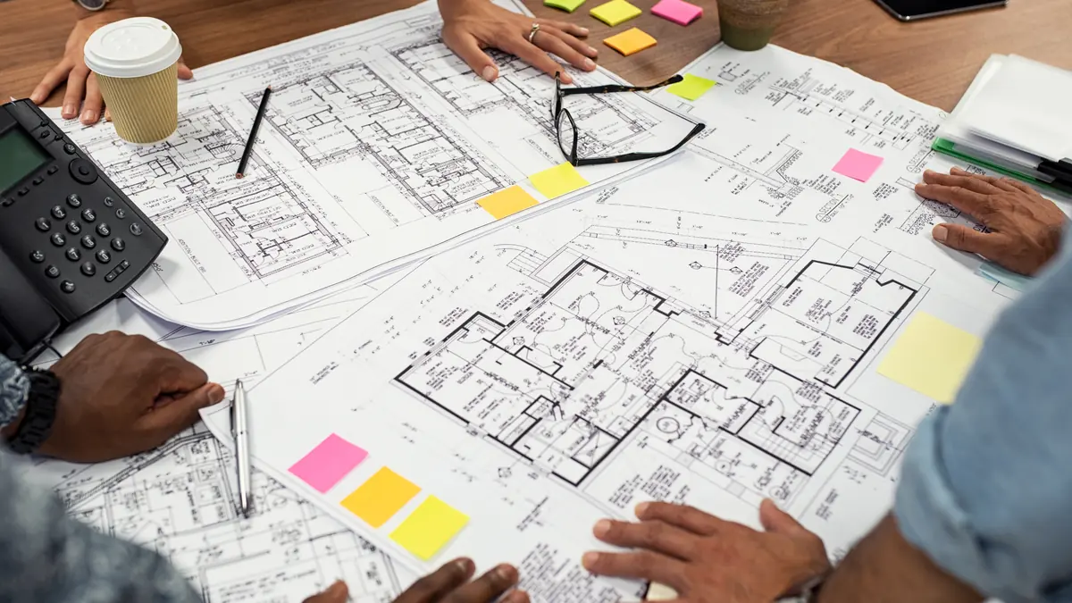 Building plans and a permit application on a desk