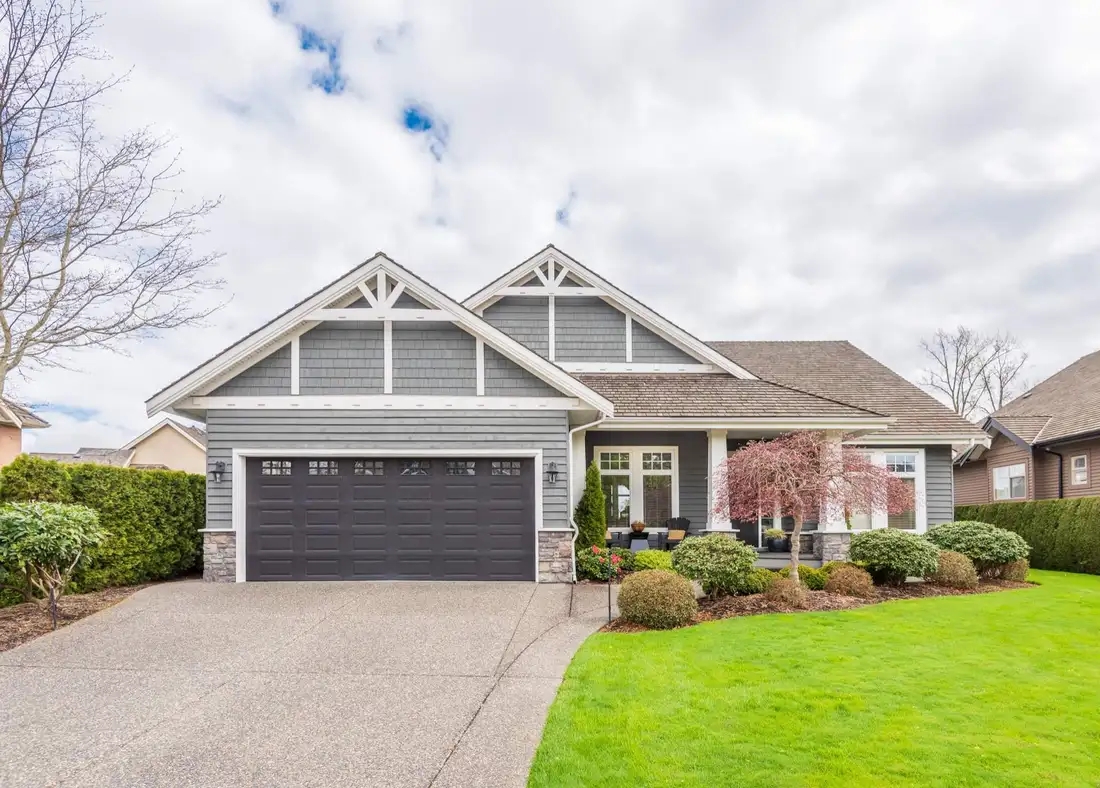 Gray craftsman-style home with lap siding and covered entry