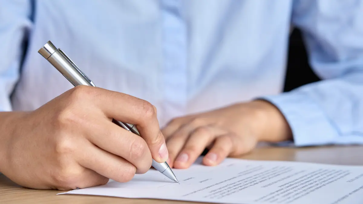 Homeowner reviewing contractor paperwork at a laptop