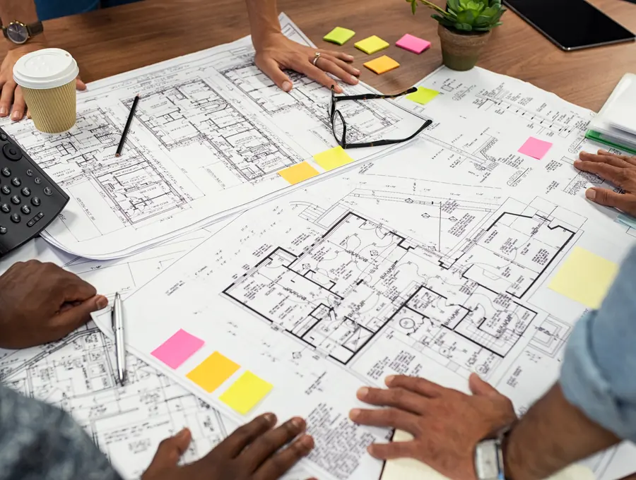Building plans and permit paperwork on a desk