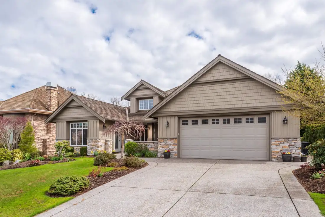 Suburban home with attached garage and landscaped front yard