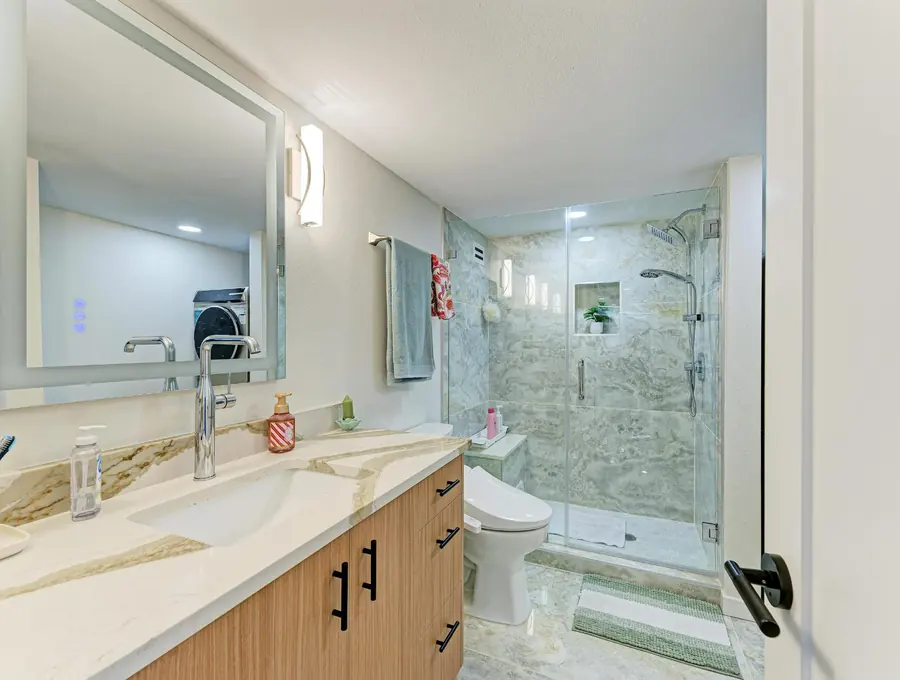 Remodeled bathroom with new vanity and tiled shower